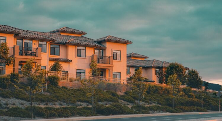 Straight-on view of a row of nearly identical modern suburban homes, representing the lack of architectural diversity in m...