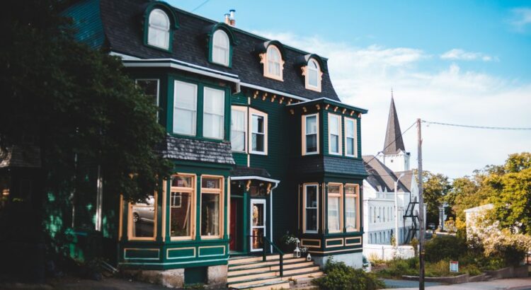 Bright, sunny residential street lined with charming traditional homes in Louisville, Kentucky, setting the scene for a lo...