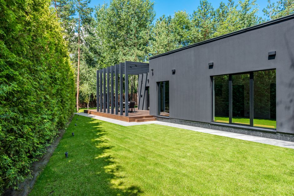 The exterior of a sleek, modern house featuring strong vertical architectural lines that create a sense of upward movement, representing a rising trend.